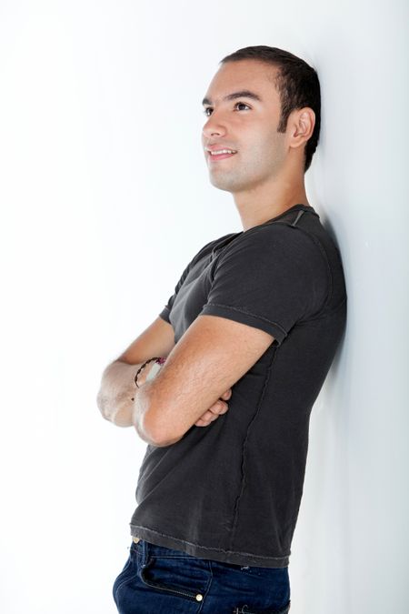 Thoughtful casual man looking up - isolated over a white background