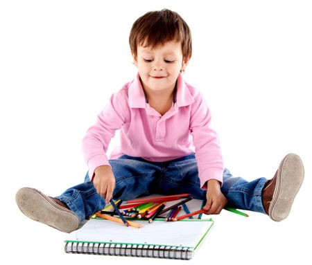 Beautiful kid on the floor with color pencils - isolated over a white background