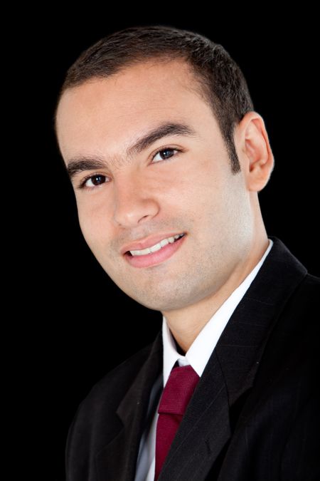 Handsome business man smiling - isolated over a black background