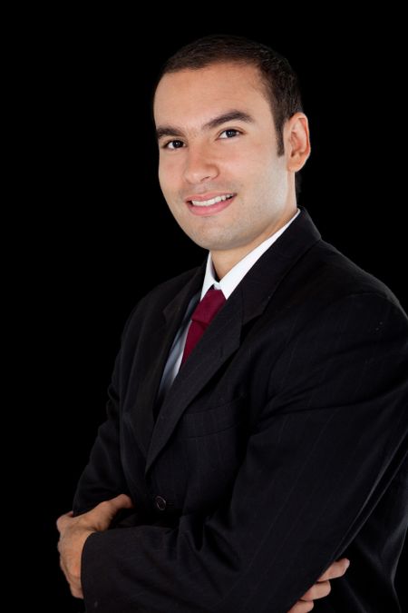 Handsome business man smiling - isolated over a black background