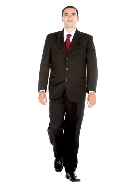 Elegant business man in a suit walking - isolated over a white background