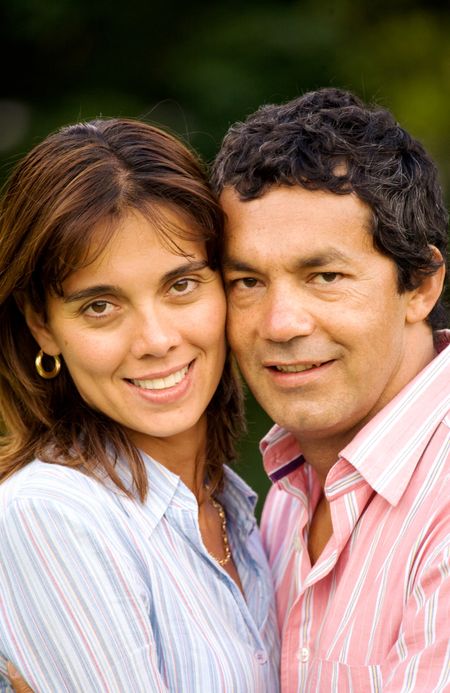 happy couple portrait outdoors both smiling in their thirties