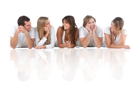 Happy group of friends lying on the floor - isolated over a white background