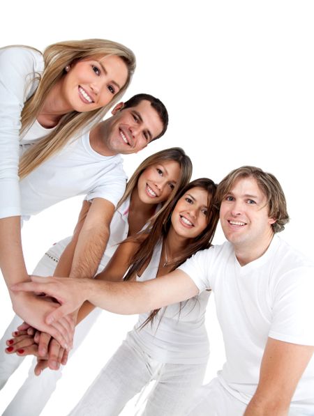 Close group of friends with hands together - isolated over a white background