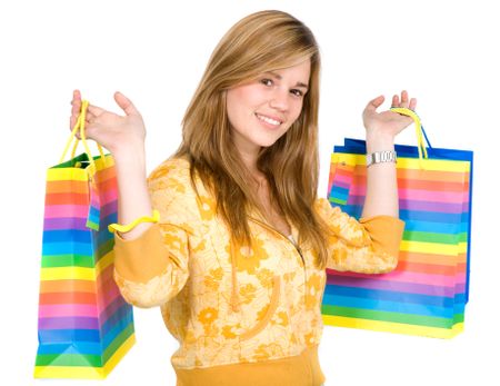 happy girl smiling holding shopping bags - isolated over a white background