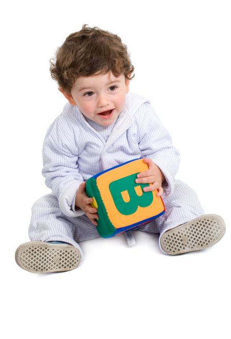 early learning boy holding a cube with the letter B isolated over a white background