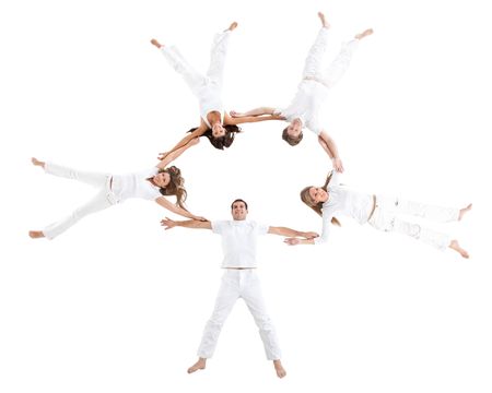 People lying on the floor making a circle and wearing white clothes ? isolated