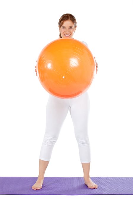 fitness woman smiling with a pilates ball isolated over a white background