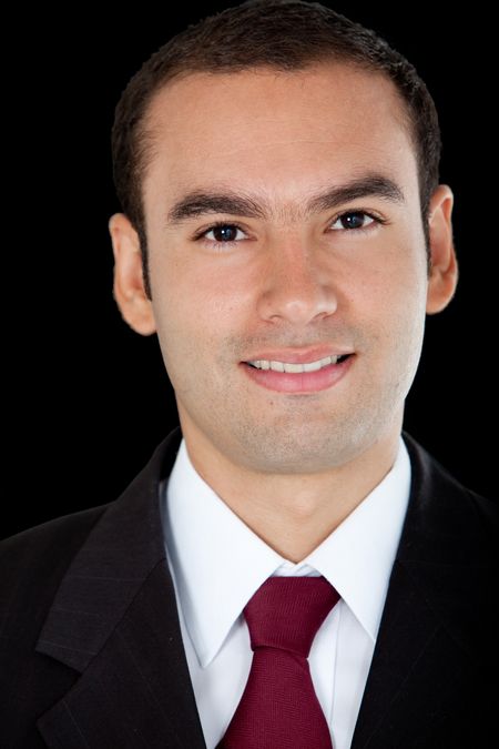 Handsome business man smiling - isolated over a black background