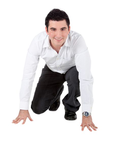 Man on his knees ready to run - isolated over a white background