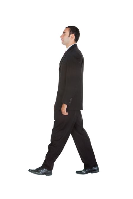 Elegant business man in a suit walking - isolated over a white background