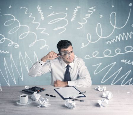 An elegant businessman sitting at office desk and working on keyboard with drawn curves, lines illustration on background wall concept