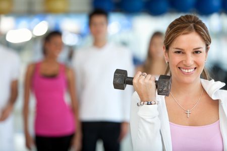 Group of people exercising at the gym with freeweights