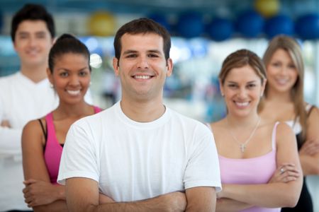 Group of athletic young people at the gym smiling