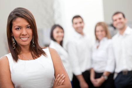 Business woman with a group at the office