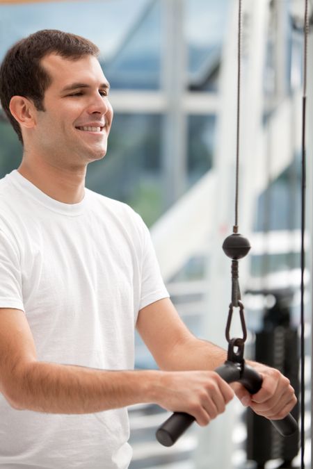 Man at the gym exercising on a machine