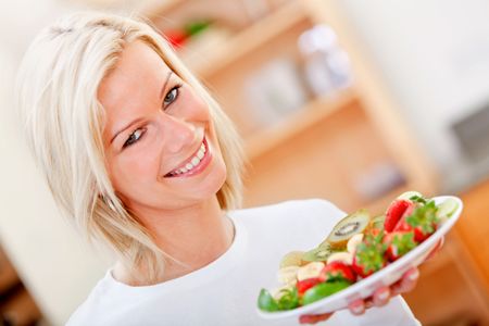 Healthy eating woman with fruits and smiling