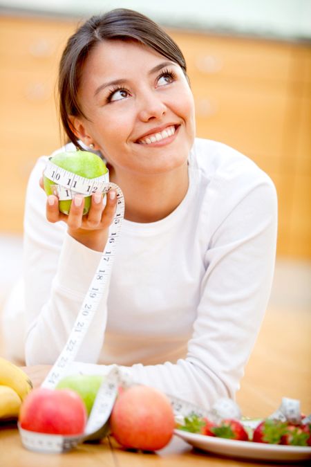 Healthy eating woman thinking about eating an apple