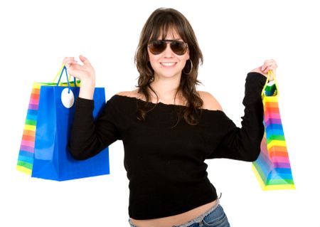 girl with shopping bags smiling - isolated over a white background