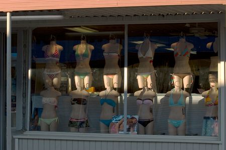 Manikins in bikinis standing in window of swimshop