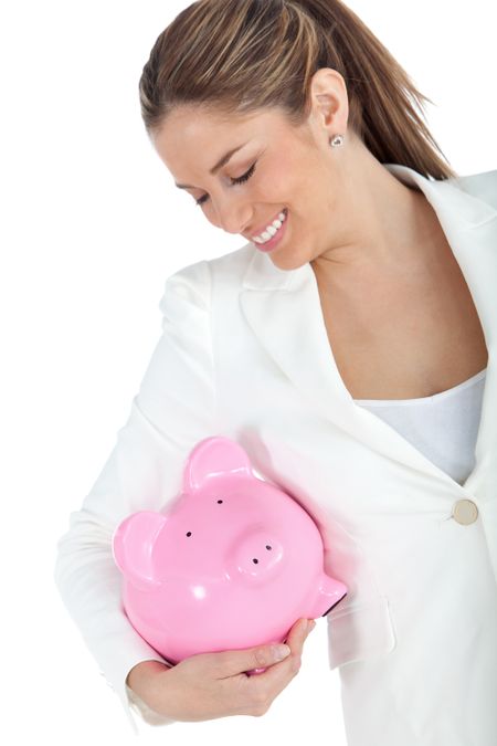 Happy business woman holding a piggybank - isolated over a white background