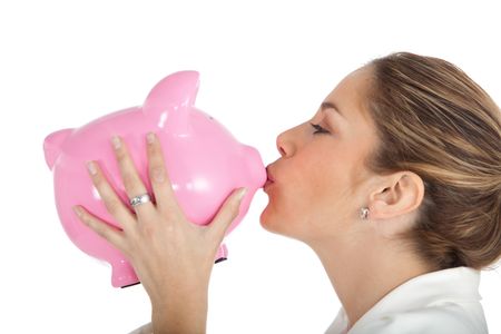 Happy business woman kissing a piggybank - isolated over a white background