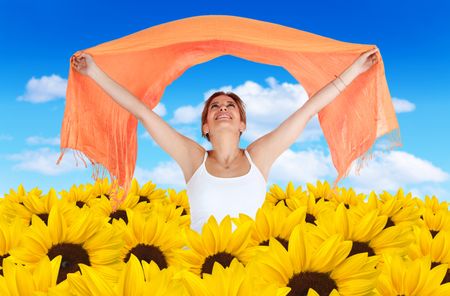 Woman in a field of beautiful yellow sunflowers with a blue sky on the background
