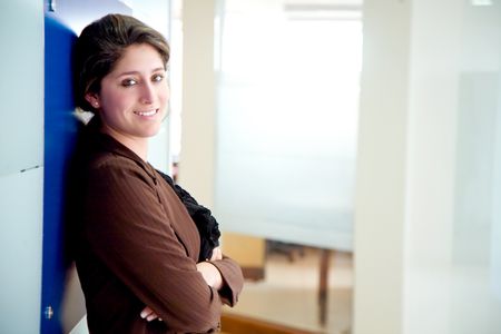 Business woman portrait smiling in an office - hispanic