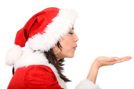 female santa blowing something on her hand isolated over a white background