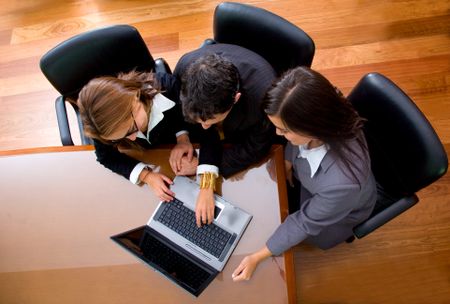 business team in an office laptop computer - meeting taken from the top at a very high angle