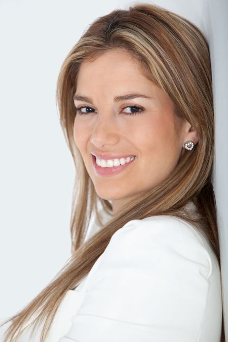 Business woman against a wall and smiling ? isolated