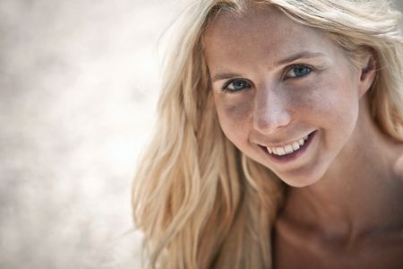 Beautiful blonde woman portrait at the beach