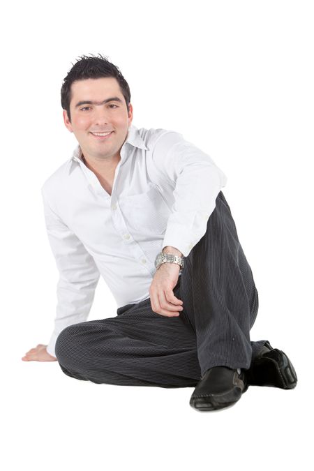 Confident man sitting on the floor - isolated over a white background