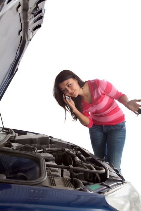 Woman having troubles with the car and talking on the phone - isolated over a white background