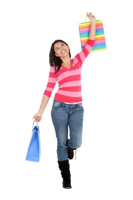 Happy shopping woman holding bags - isolated white background