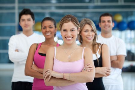 Group of athletic young people at the gym smiling