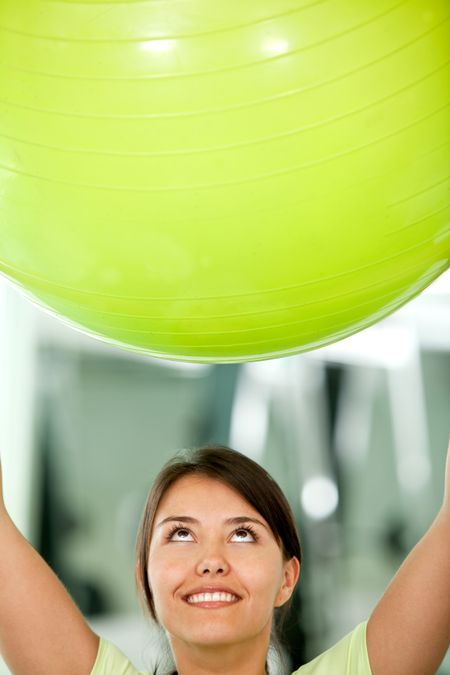 Woman at the gym lifting a pilates ball