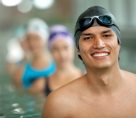 Portrait of a male swimmer wearing a swimming cap and goggles