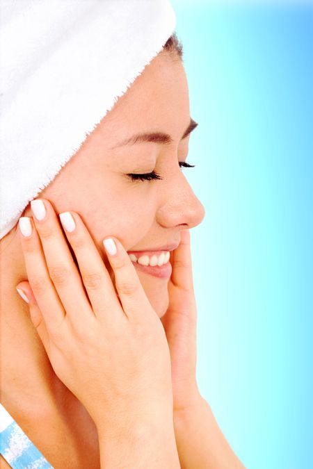 beauty and spa portrait of a very healthy looking girl over a light blue background