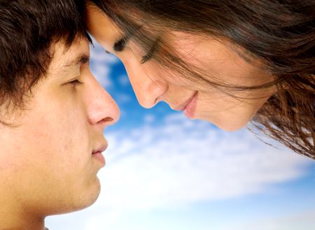 couple of lovers in love face to face - over a blue sky