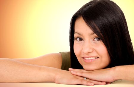 beautiful female portrait smiling over a golden background
