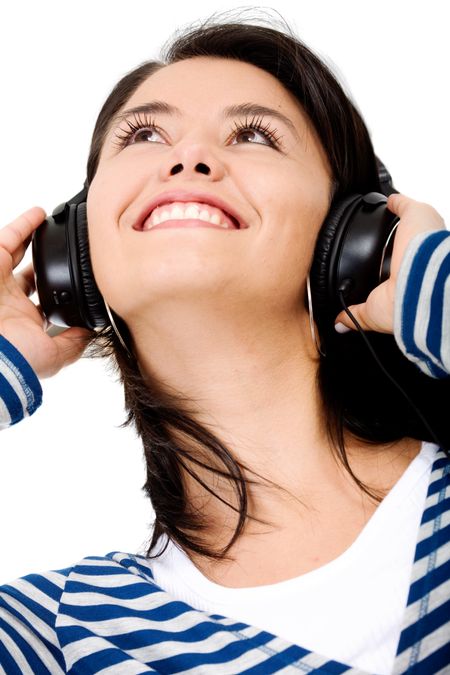 girl listening to music smiling and enjoying herself - isolated over a white background
