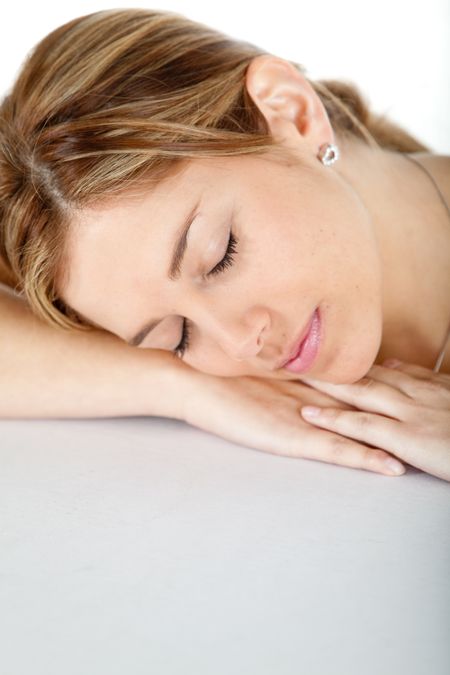 casual woman sleeping and leaning on her hands isolated over a white background