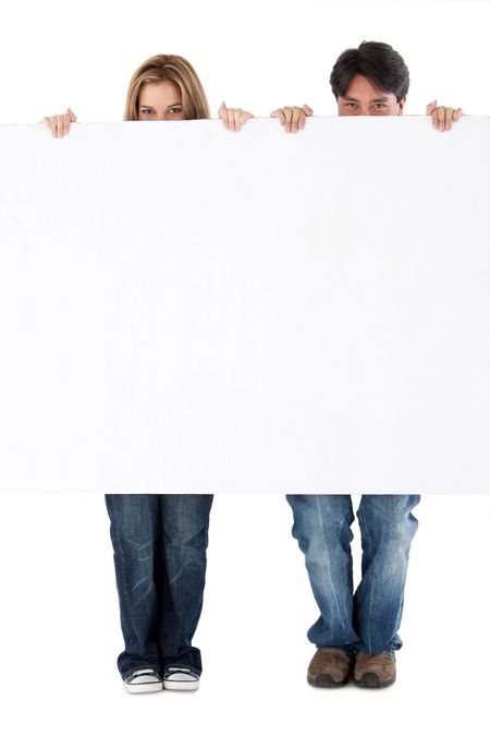 Beautiful couple displaying a banner ad isolated over a white background