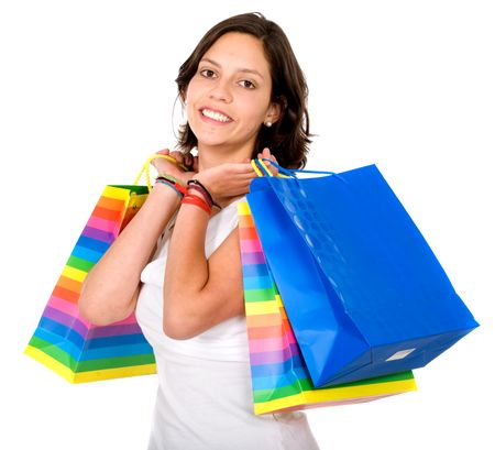 happy girl smiling holding shopping bags - isolated over a white background