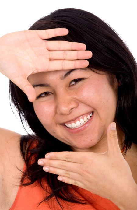 asian girl doing a handframe and smiling - isolated over a white background
