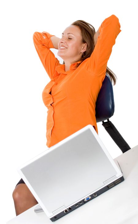 Business woman on a laptop computer relaxing at her desk isolated over a white background