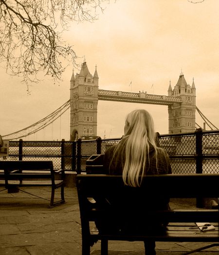 Blond woman in sepia admiring Tower Bridge