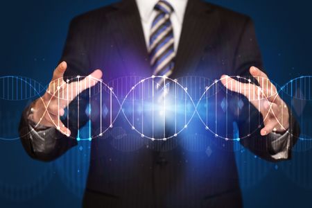 Businessman with DNA concept in his hands 