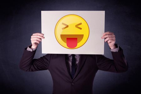 young-businessman-hiding-playful-emoticon-cardboard-588163694 Young businessman hiding behind a playful emoticon on cardboard